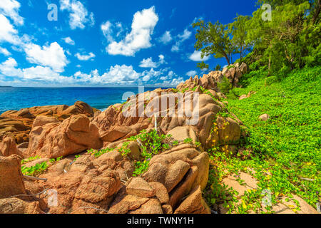 Scenic landscape of natural pool in La Digue, Seychelles. Turquoise calm waters of swimming pools at Anse Caiman remote beach between Anse Fourmis and Stock Photo
