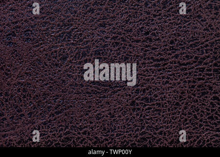 Dark brown background from a soft upholstery textile material, closeup. Matte umber velvet fabric with natural texture. Cloth ornate backdrop. Stock Photo