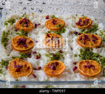 traditional Turkish dessert: gullac; with peanuts, dried orange slices and dried pomegranate seeds Stock Photo