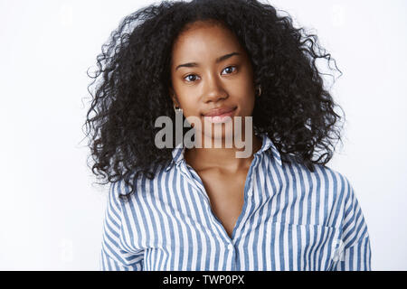 Close-up sincere hopeful charming friendly-looking dark-skinned young university student afro hairstyle tilting head looking faithful camera smiling d Stock Photo