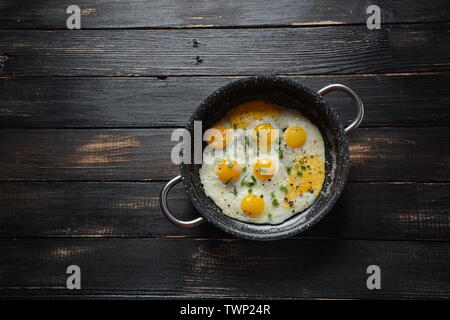 Fried quail eggs in a pan for breakfast. Healthy organic food Stock Photo