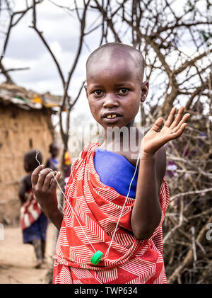 MASAI VILLAGE, KENYA - OCTOBER 11, 2018: Unindentified african child wearing traditional clothes in Masai tribe, Kenya Stock Photo