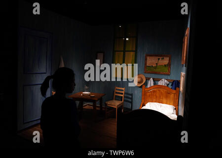 Beijing, China. 22nd June, 2019. A visitor views an exhibition area mimicking Vincent van Gogh's bedroom during the Van Gogh Immersive Experience 'Fantasy of The Inner World' at the National Museum of China, Beijing, capital of China, June 22, 2019. The exhibition, which kicked off here on Saturday, offers visitors a 360-degree view of over 200 works of Vincent van Gogh. Credit: Jin Liangkuai/Xinhua/Alamy Live News Stock Photo