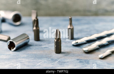 Bits for a screwdriver and socket wrench on wooden background. Close up. Stock Photo