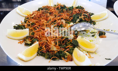 Spinach and onions, Lebanese cuisine. Sidon, Lebanon - June, 2019 Stock Photo