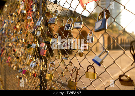 Love Padlocks on a fence outside Shoreditch High Street station, near Brick Lane and Shoreditch on the border of Spitalfields and Bethnal Green Stock Photo