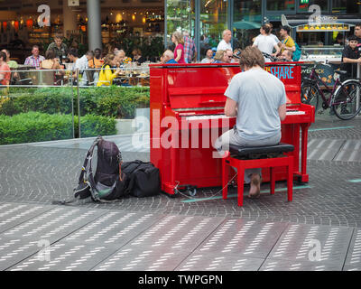 BERLIN, GERMANY - CIRCA JUNE 2019: man playing piano in Potsdamer Platz Stock Photo