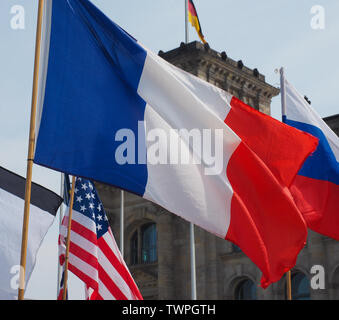 French, Russian and American flags in front of German Bundestag parliament Stock Photo