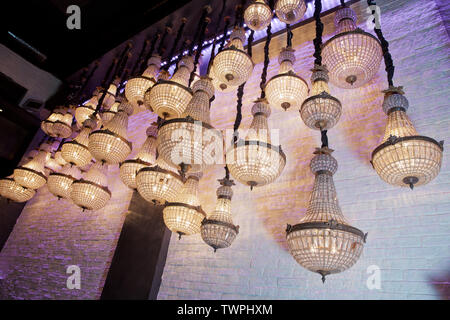 Range of lantern and lamp hanging in the restoran . abstract shining light with chandeliers crystal in dark night. Luxury star light in dark for backg Stock Photo