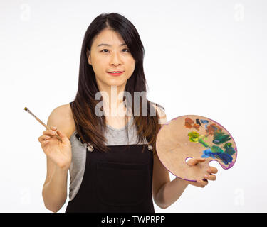 Artist holding painting palette and brush Stock Photo