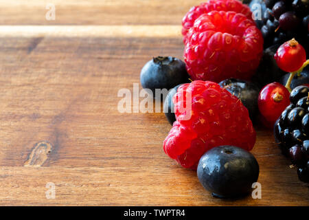 A close up of berries: raspberries, blackberries, blueberries, red currants. Wonderful vivid colors Stock Photo