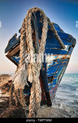 Old wrecked wooden rowing boat on the shore Stock Photo - Alamy
