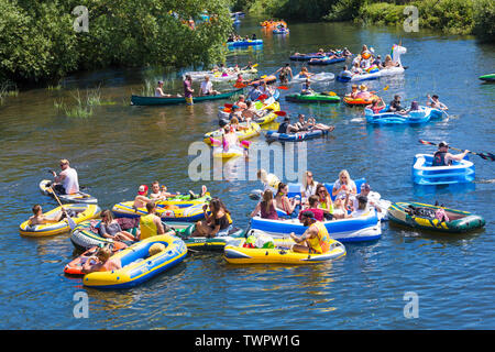 Iford, Dorset, UK. 22nd June 2019. Perfect weather, warm sunny and still, for Dorset Dinghy Day with hundreds of inflatables, dinghies, crafts, boards forming a flotilla, setting sail from Iford bridge down the River Stour to Tuckton bridge. The event started in 2014 as a little bit of fun, but has now become an annual event raising money for charity and getter bigger each year. Credit: Carolyn Jenkins/Alamy Live News Stock Photo