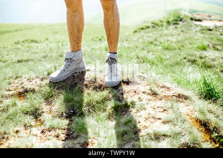 Close-up of a male legs in trekking shoes outdoors Stock Photo