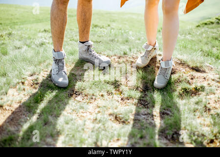 Close-up of a couple's legs in trekking shoes outdoors Stock Photo