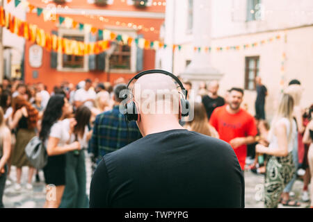 Outdoor party, DJ and blurred people in the background. Festive summer event. Stock Photo