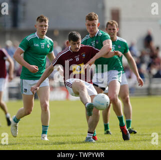 Westmeath, Ireland. June 22nd 2019, TEG Cusack Park, Westmeath, Ireland; GAA Football All-Ireland Senior Championship Westmeath versus Limerick; Jack Smyth (Westmeath) plays the ball away under pressure from Tony McCarthy and Padraig De Brun (Limerick) Credit: Action Plus Sports Images/Alamy Live News Stock Photo