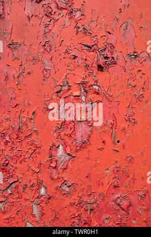 Old painted red wooden door with peeling paint texture Stock Photo