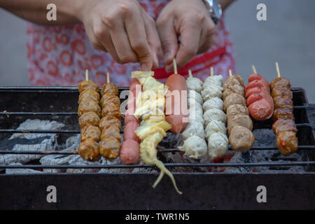 grill meat balls and squid with stick the famous street food of Thailand. Stock Photo