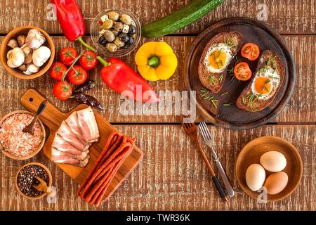 Fried bread with egg and bacon. Hearty meal. Vegetables and fried egg. Healthy breakfast. Stock Photo