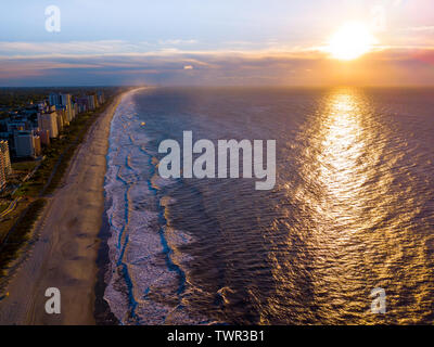 Drone view of the shore line and beach at sunrise Stock Photo