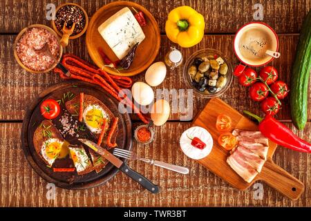 Fried bread with egg and bacon. Hearty meal. Vegetables and fried egg. Healthy breakfast. Stock Photo