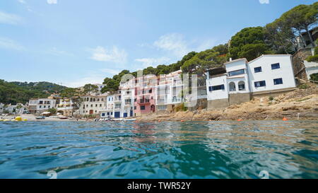 Coastal Mediterranean village on the Costa Brava in Spain, seen from sea surface, Sa Tuna, Begur, Catalonia Stock Photo