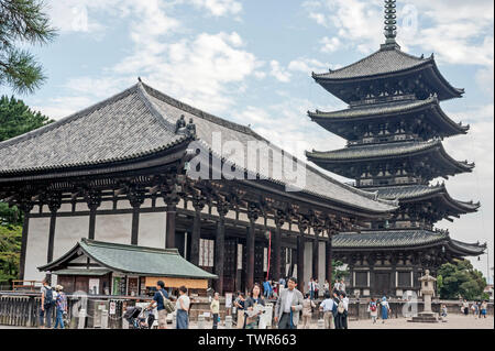 Tourists and worshippers enjoying the Buddhist wooden Horyuji Temple and five storey Pagoda in Nara Park, Kyoto, Japan. Stock Photo