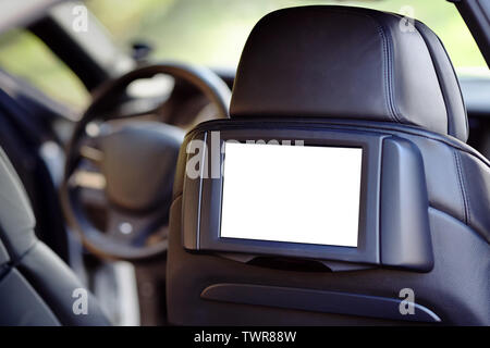 Car inside headrest screen mock up. Interior of prestige luxury modern car. One white display for back seats passenger with copy space and place for t Stock Photo