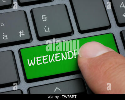 Closeup finger typing on weekend key on computer keyboard Stock Photo