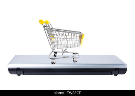 Shopping cart on closed laptop isolated on white. Electronic commerce concept Stock Photo