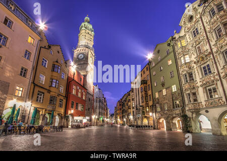 Evening scene in central Innsbruck, Austria along the famous Herzog-Friedrich scene with the Stadtturm (City Tower) and other famous historical houses Stock Photo