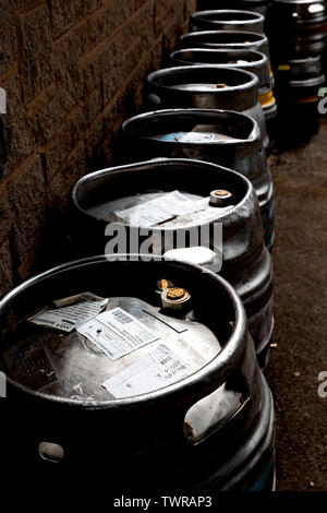 Empty beer barrels stacked up outside an English bar Stock Photo