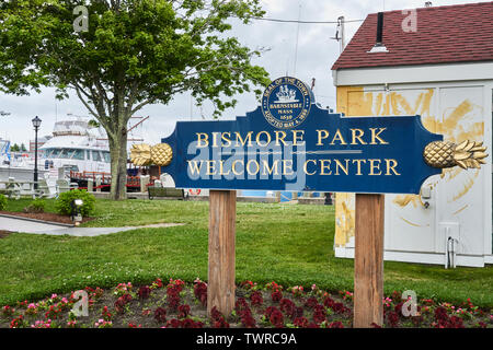 Hyannis, MA - June 10, 2019: Welcome sign in Bismore park has gold pineapples on each end and the Seal of the Town of Barnstable Massachusetts. Hyanni Stock Photo