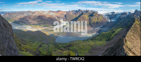 Panoramic view from the top of a mountain ridge of Vatnajokull icefield in Skaftafell National Park, Iceland. Glacier tongue with moraine and lagoon. Stock Photo