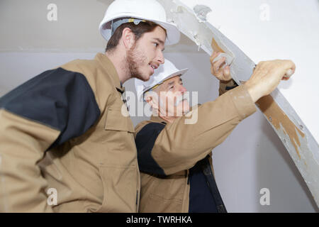 two builders making finish in the apartment Stock Photo