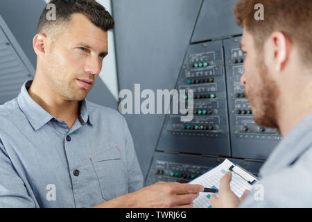 aero engineer and apprentice working in hangar Stock Photo
