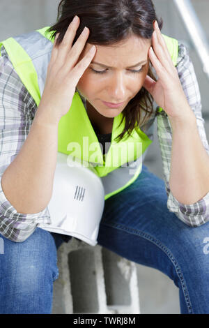 Tired exhausted engineer woman hard work in modern robotic factory ...