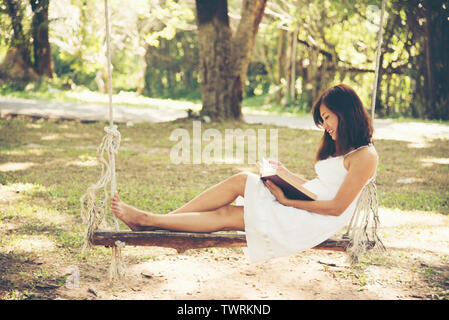 Relaxation woman reading a book in the park Stock Photo