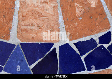 Texture of floor made of orange and blue pieces of tiles. There is also some grey cement in between. Beautiful colorful surface! Stock Photo