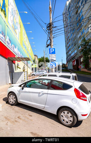 Samara, Russia - June 9, 2019: Different vehicles parked up on the city street in summer sunny day Stock Photo