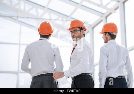rear view.businessman and architects standing in the new office Stock Photo