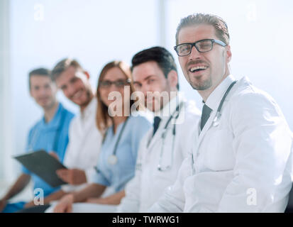 Students in white coats listen to lecture in audience Stock Photo