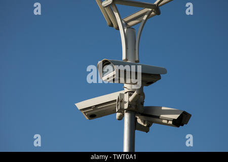 Security camera record live, Security camera on blue sky background. Stock Photo