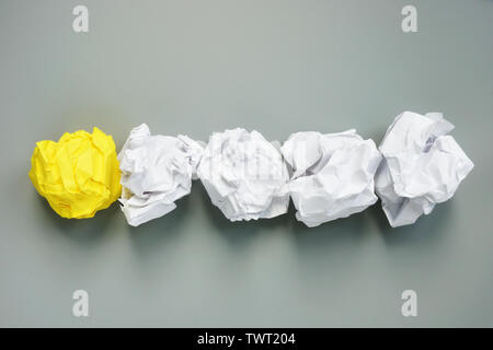 Be different concept. Line of paper balls and yellow one. Creativity and individuality. Stock Photo
