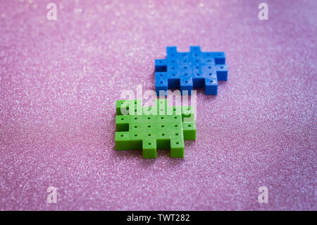 Colorful plastic puzzle pieces on pink Background. Stock Photo