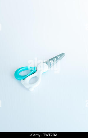 children's colourful safe scissors on a white background. scissors made of plastics to avoid injuries. Stock Photo