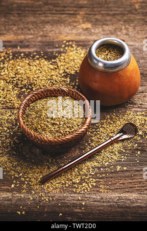 Mate yerba tea in calabash on wooden table. Stock Photo