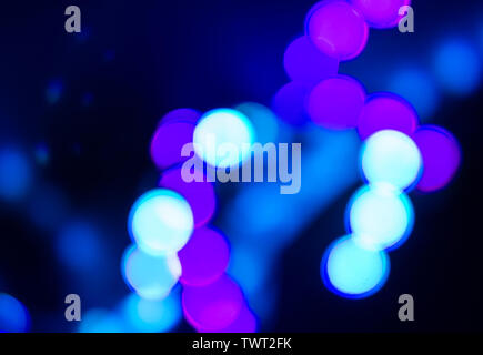 Duotone abstraction of blurry neon lights on black. Stock Photo