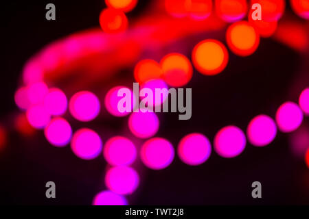 Duotone Red and purple neon lights on black. Abstract night blurred background. Stock Photo